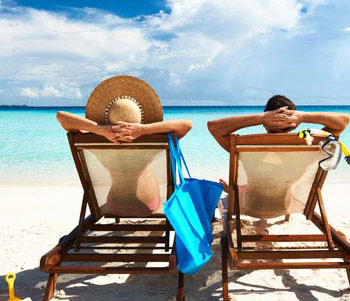 2 people sitting in chairs at the Florida beach 