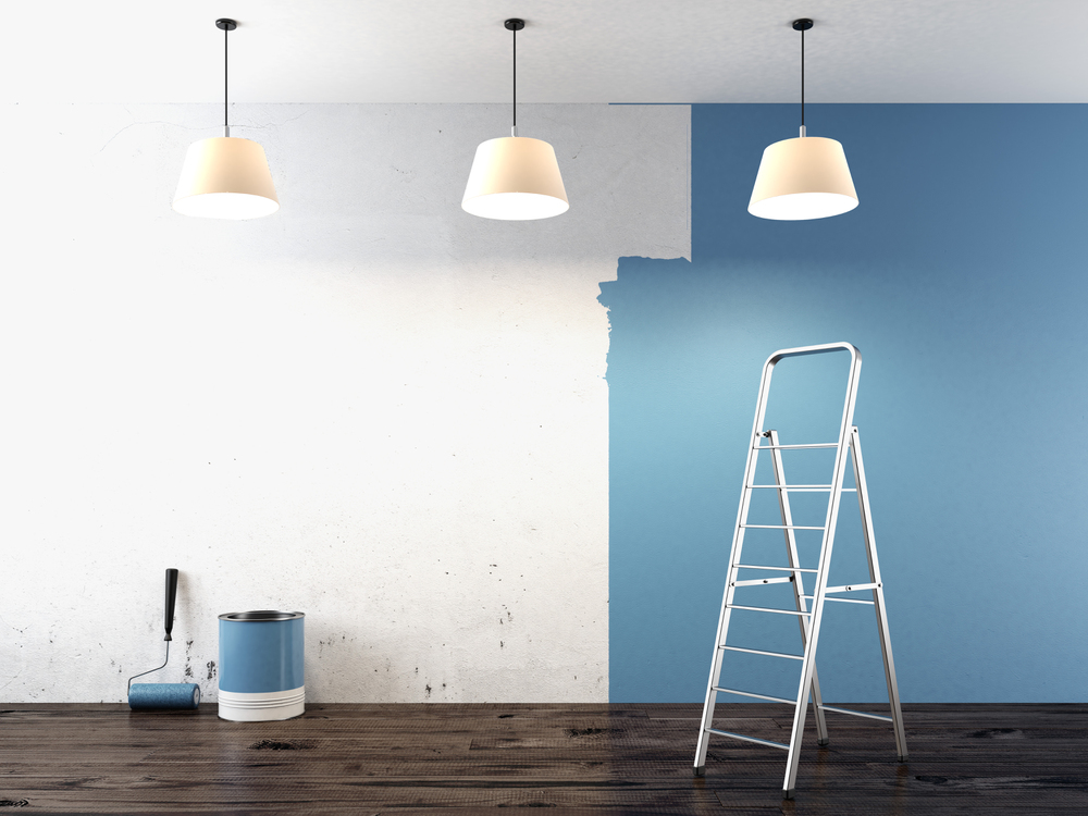 a ladder and paint bucket in a room of a mobile home