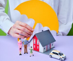 yellow umbrella under a family with house and car