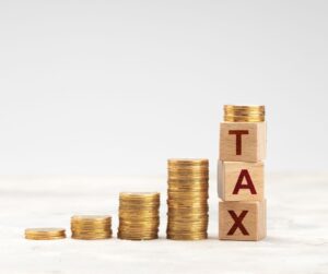 coins with blocks saying taxes