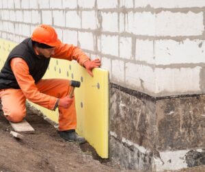 man installing foam board Skirting for Manufactured Homes